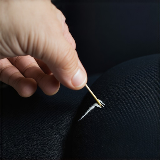 Applying adhesive and harvested fibers to a small burn hole on a fabric theater seat.